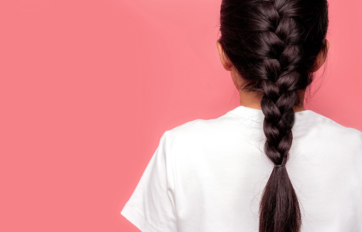 Back shot of a woman with a loosely tied plait or braid