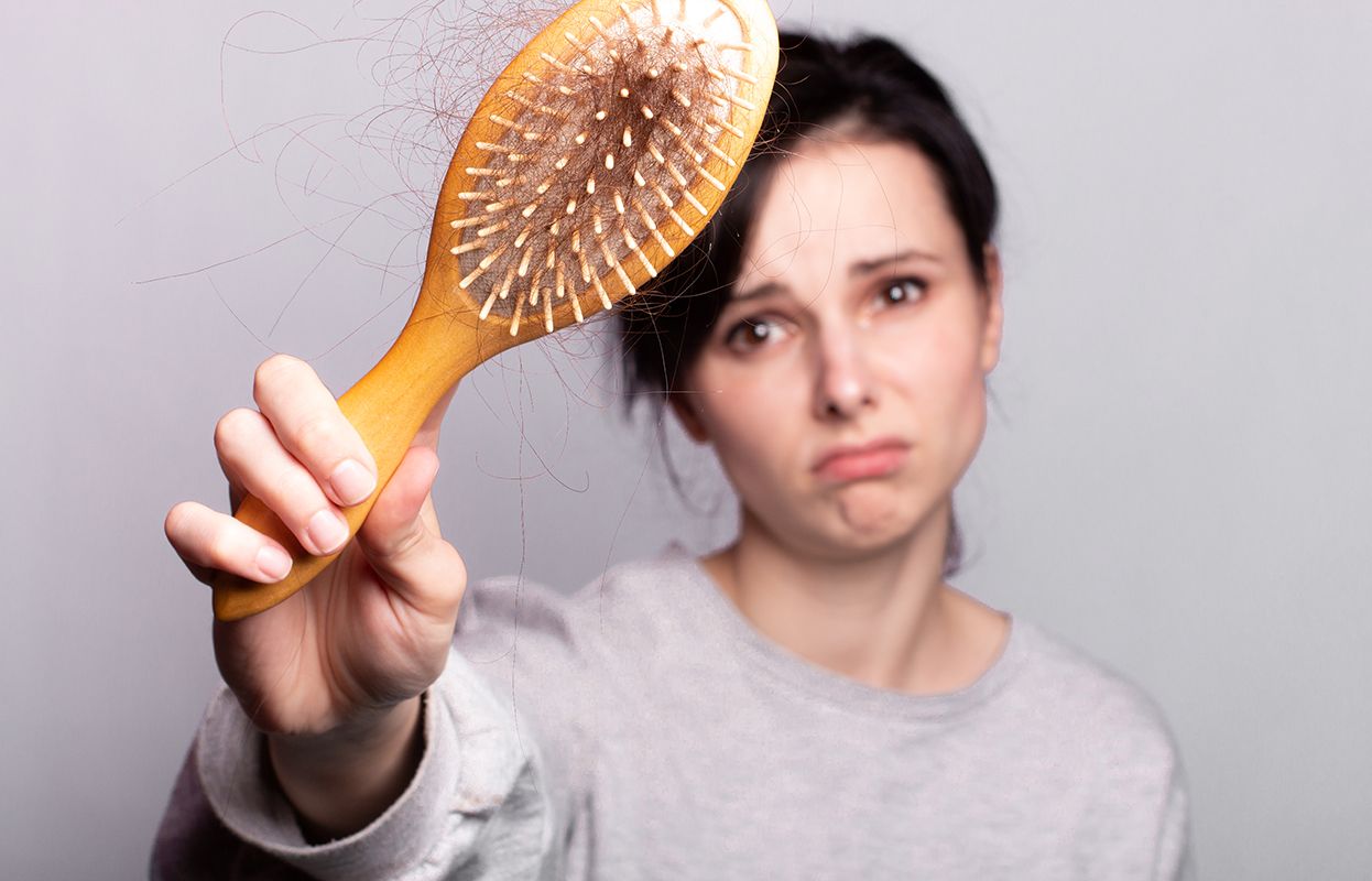 Weak hair, broken hair, and a sad woman with hair in a comb