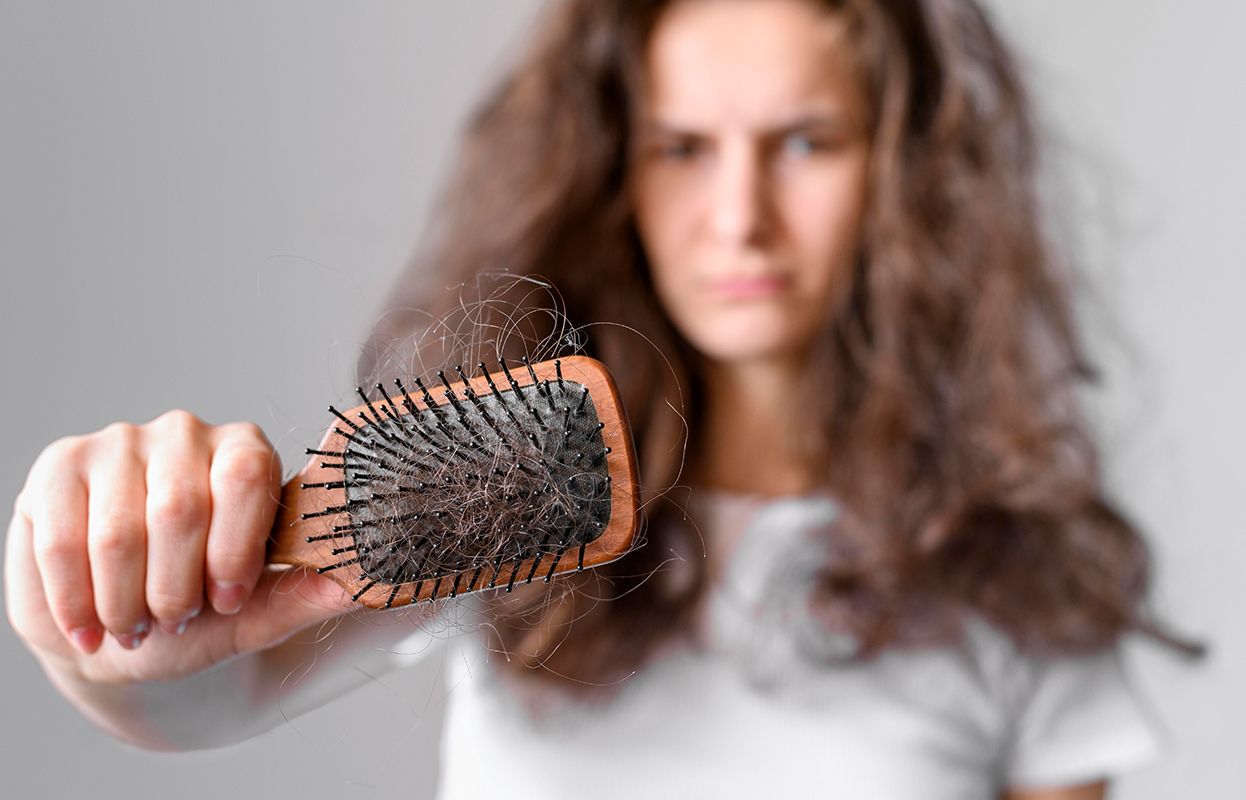 Woman irritated with her dry hair 
