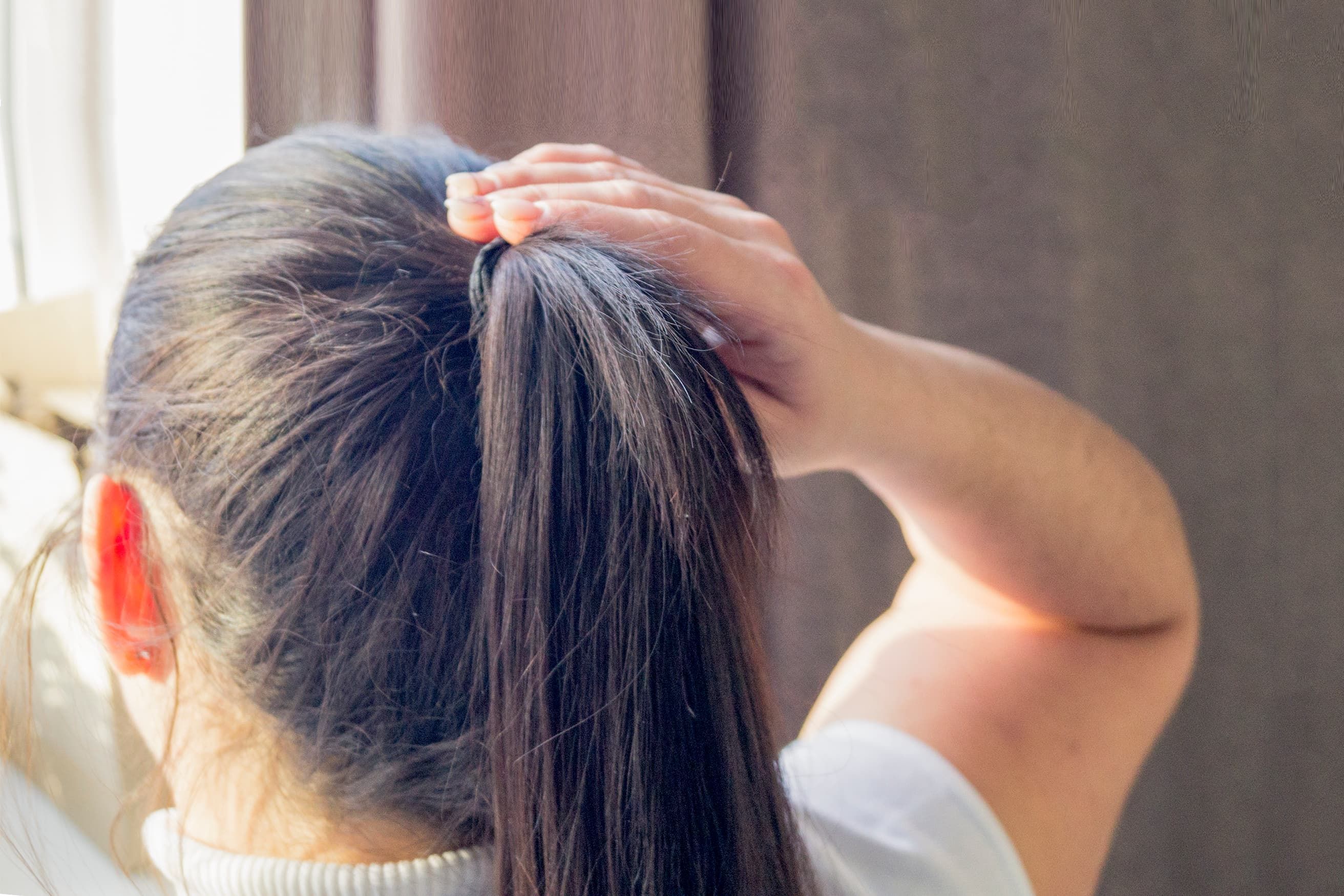 Girl tieing her hair