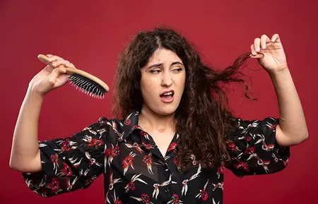 Women Holding Comb and Rough Hair