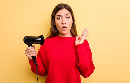 Girl holding Blow dryer