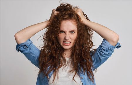 Angry Woman with Hands in Hair