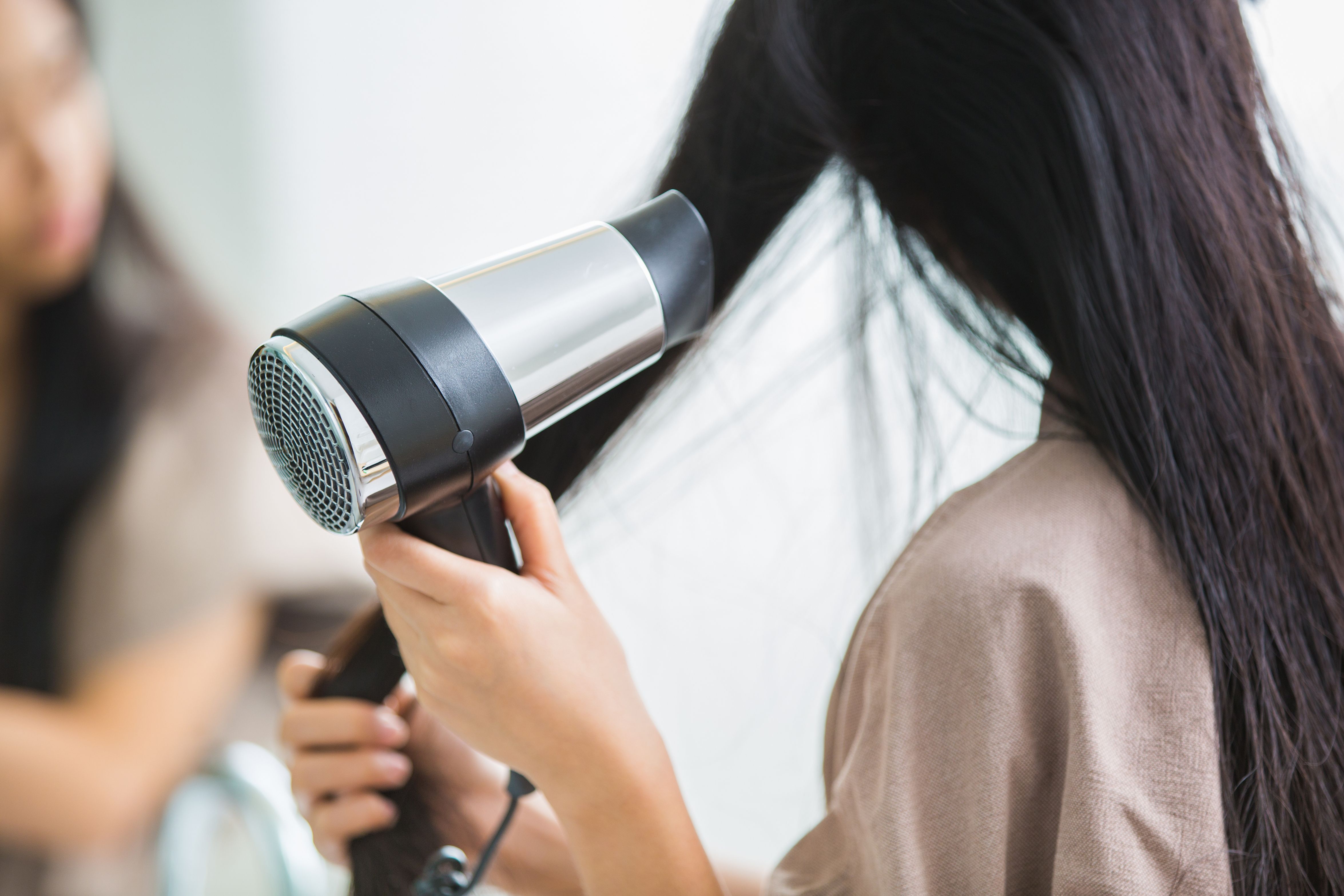 Girl blow drying her hair