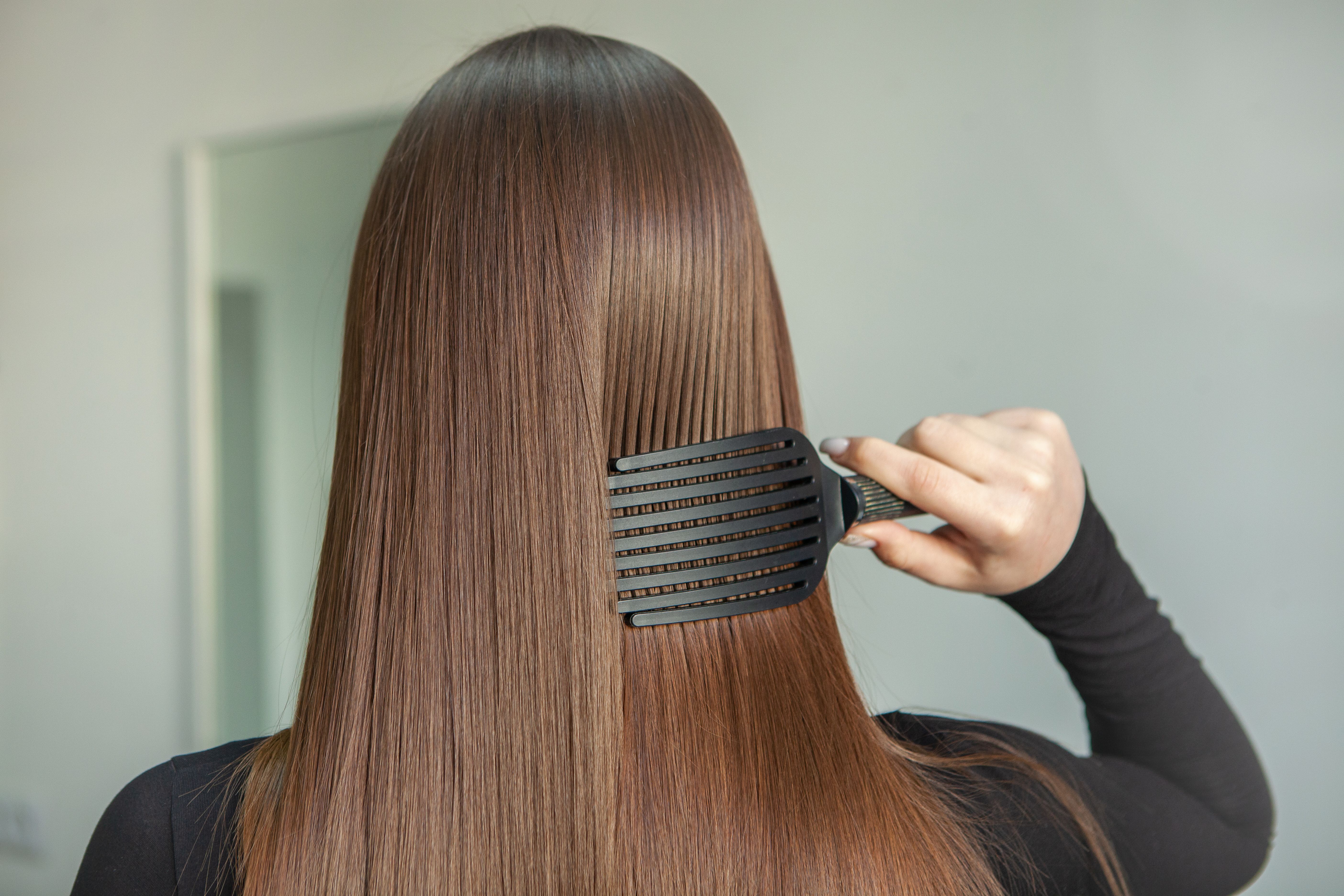 Girl combining her thick hair