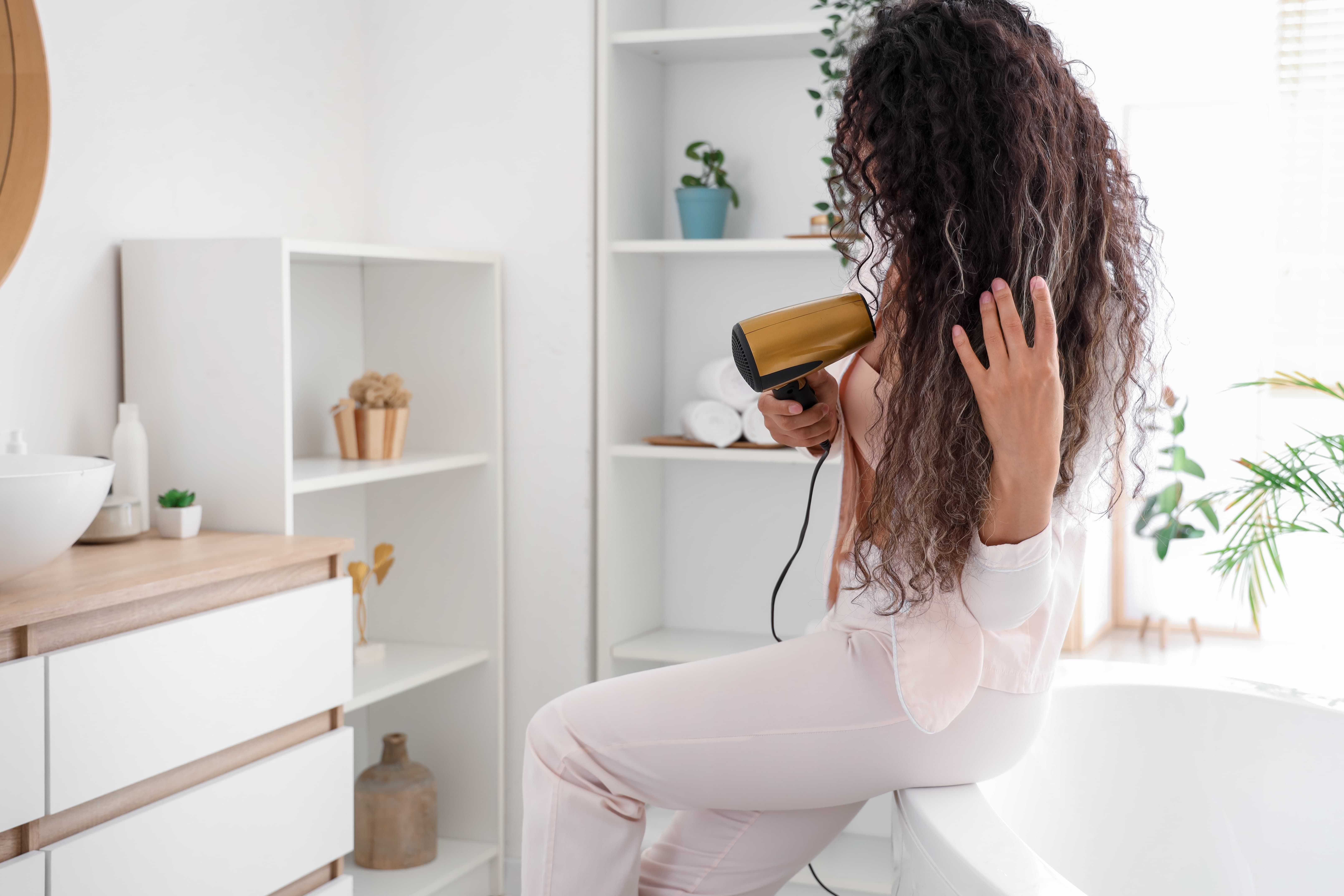 Girl using blow dryer
