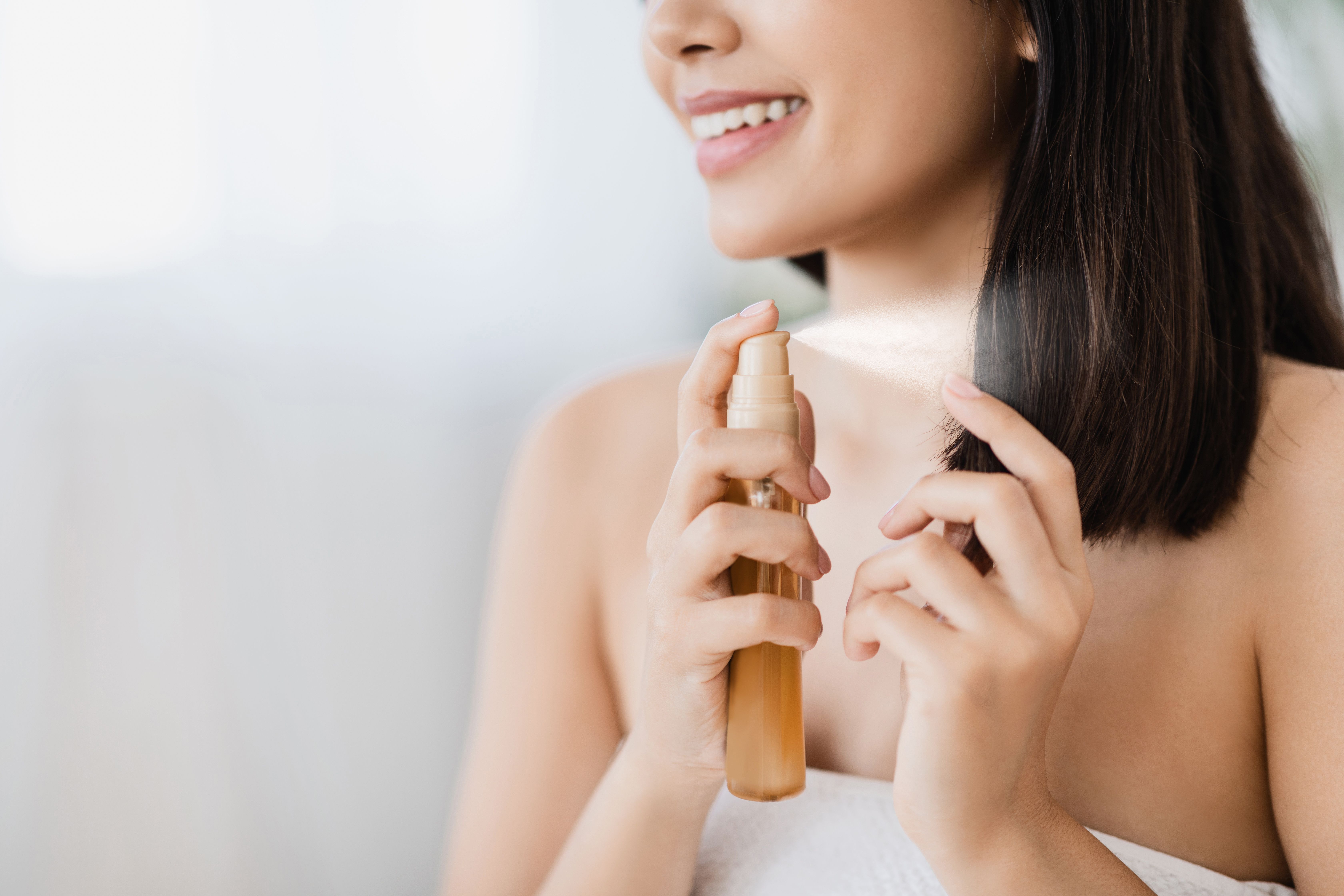Girl applying Hair Perfume