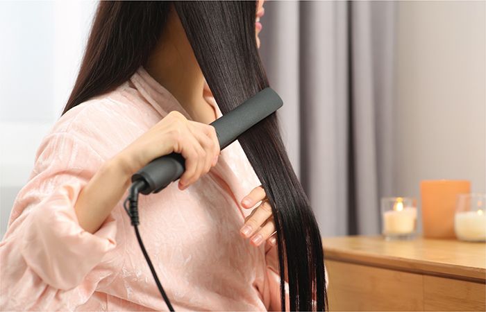 woman using hair straightner