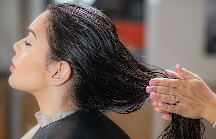 Girl applying non-sticky hair oil