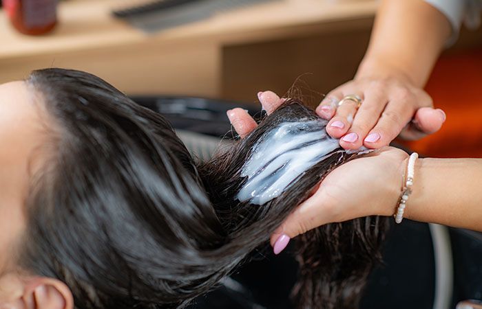 Girl applying Hair mask on her hair