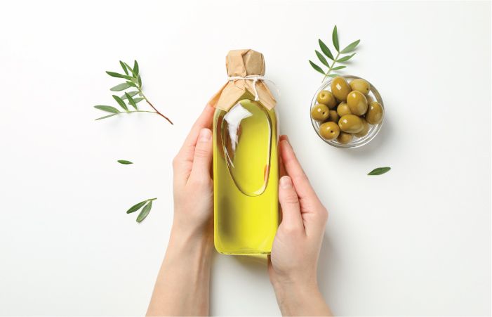 Female hands holding Hair Oil Bottle