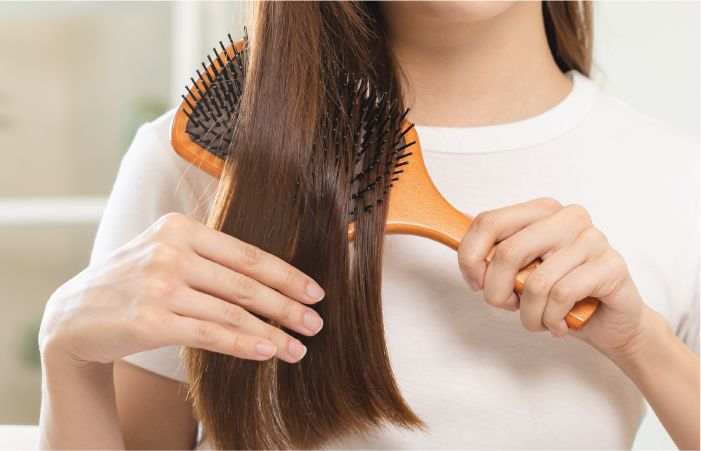 Girl Using A Comb on Hair