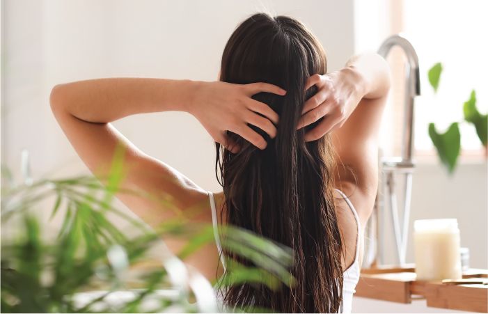 Women Applying Coconut Hair Oil