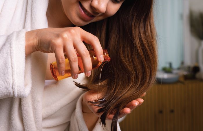 Women Applying Hair Oil