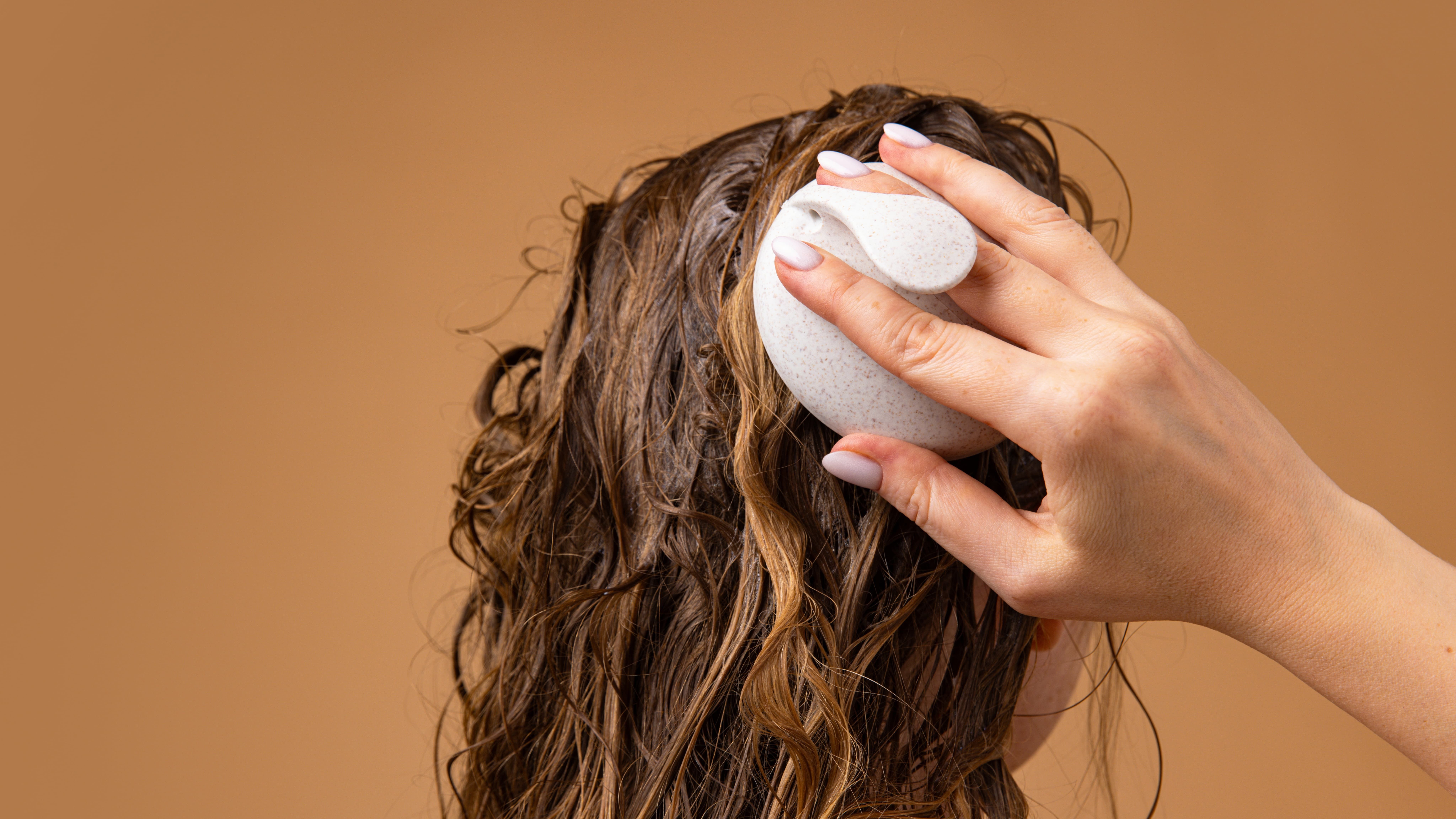 Girl massaging her hair with oil